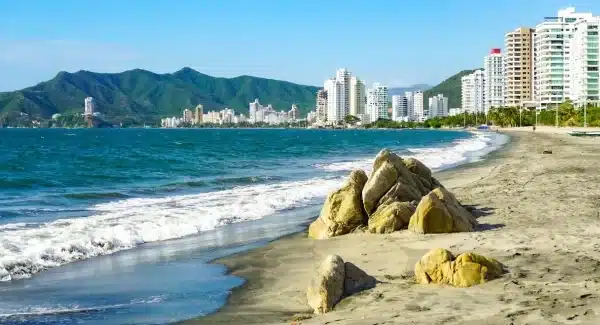 Playa del Rodadero: Aguas tranquilas, arena gris y montañas circundantes